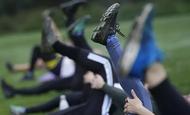 A participants takes part in an outdoor gym class led by personal fitness trainer Richard Lamb, during an outdoor gym class in London, Saturday, Oct. 26, 2024. (AP Photo/Alastair Grant)