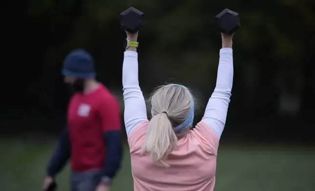 Personal fitness trainer Richard Lamb, leads a group in an outdoor gym class in London, Saturday, Oct. 26, 2024. (AP Photo/Alastair Grant)