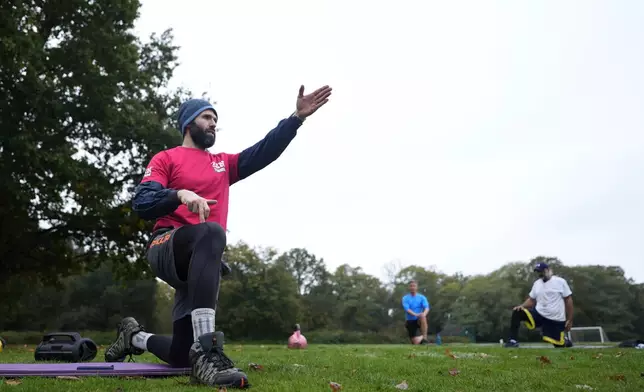 Personal fitness trainer Richard Lamb, gestures as he leads an outdoor gym class in London, Saturday, Oct. 26, 2024. (AP Photo/Alastair Grant)