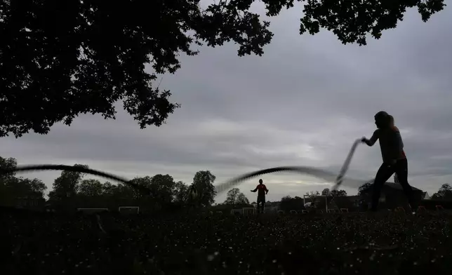 A participant takes part in an outdoor gym class led by personal fitness trainer Richard Lamb in London, Saturday, Oct. 26, 2024, Lamb works for Alan Ezen, and his company Zen Training. (AP Photo/Alastair Grant)