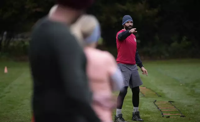 Personal fitness trainer Richard Lamb, leads a group in an outdoor gym class in London, Saturday, Oct. 26, 2024. Lamb works for Alan Ezen, and his company Zen Training. (AP Photo/Alastair Grant)