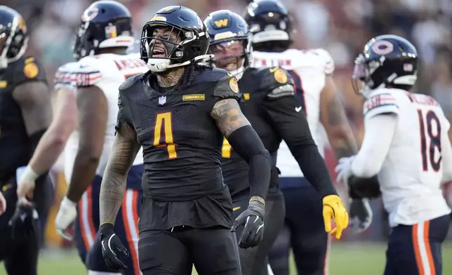 Washington Commanders linebacker Frankie Luvu (4) celebrates after tackling Chicago Bears quarterback Caleb Williams (18) in the first half of an NFL football game Sunday, Oct. 27, 2024, in Landover, Md. (AP Photo/Stephanie Scarbrough)