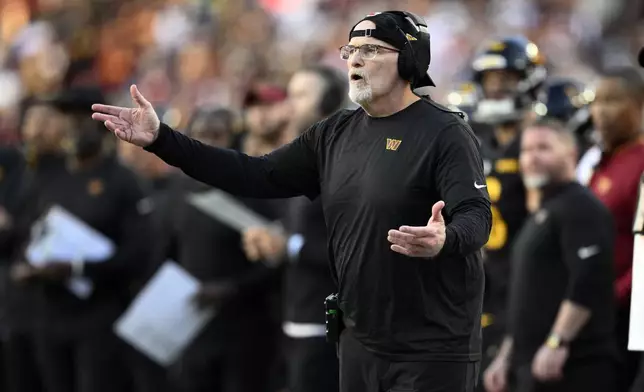 Washington Commanders head coach Dan Quinn watches from the sideline in the first half of an NFL football game against the Chicago Bears Sunday, Oct. 27, 2024, in Landover, Md. (AP Photo/Nick Wass)