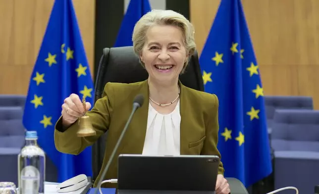 European Commission President Ursula von der Leyen rings a bell to signify the beginning of the weekly college of commissioners meeting at EU headquarters in Brussels on Wednesday, Oct. 30, 2024. (AP Photo/Virginia Mayo)