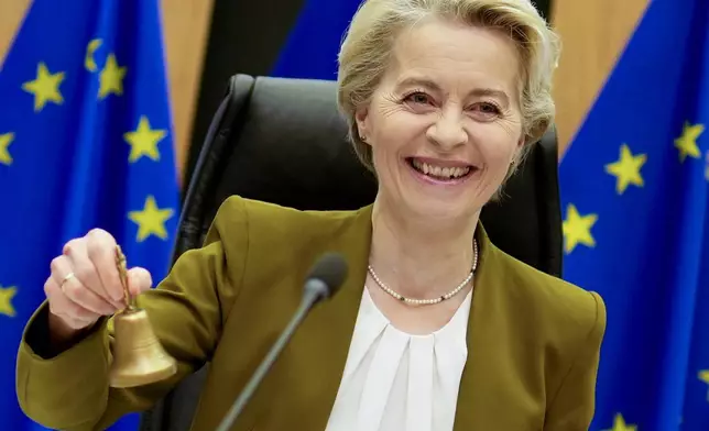 European Commission President Ursula von der Leyen rings a bell to signify the beginning of the weekly college of commissioners meeting at EU headquarters in Brussels on Wednesday, Oct. 30, 2024. (AP Photo/Virginia Mayo)