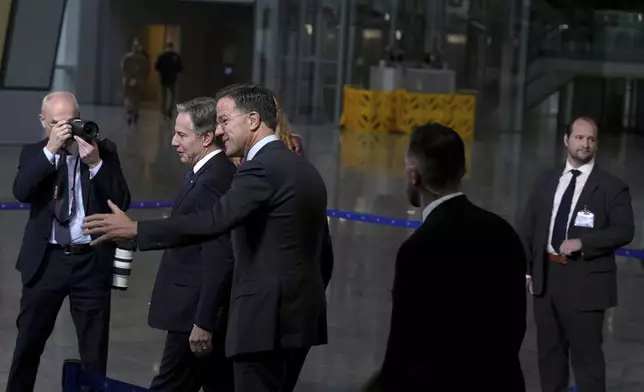 NATO Secretary General Mark Rutte, center right, walks with United States Secretary of State Antony Blinken, center left, prior to delivering a statement at NATO headquarters in Brussels on Wednesday, Nov. 13, 2024. (AP Photo/Virginia Mayo)