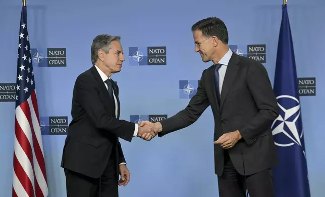 NATO Secretary General Mark Rutte, right, shake hands with United States Secretary of State Antony Blinken prior to a meeting at NATO headquarters in Brussels, Wednesday, Nov. 13, 2024. (Nicolas Tucat, Pool Photo via AP)