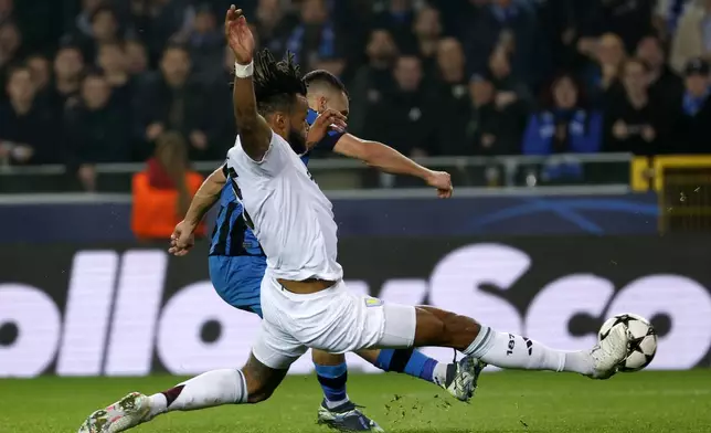 Brugge's Ferran Jutgla, background, makes an attempt to score as Aston Villa's Tyrone Mings defends during the Champions League opening phase soccer match between Club Brugge and Aston Villa at Jan Breydelstadion in Bruges, Belgium, Wednesday, Nov. 6, 2024. (AP Photo/Geert Vanden Wijngaert)