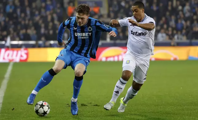 Brugge's Andreas Skov Olsen, left, and Aston Villa's Youri Tielemans fight for the ball during the Champions League opening phase soccer match between Club Brugge and Aston Villa at Jan Breydelstadion in Bruges, Belgium, Wednesday, Nov. 6, 2024. (AP Photo/Geert Vanden Wijngaert)