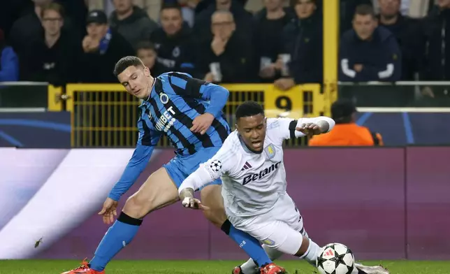 Brugge's Christos Tzolis, left, stops Aston Villa's Ezri Konsa during the Champions League opening phase soccer match between Club Brugge and Aston Villa at Jan Breydelstadion in Bruges, Belgium, Wednesday, Nov. 6, 2024. (AP Photo/Geert Vanden Wijngaert)