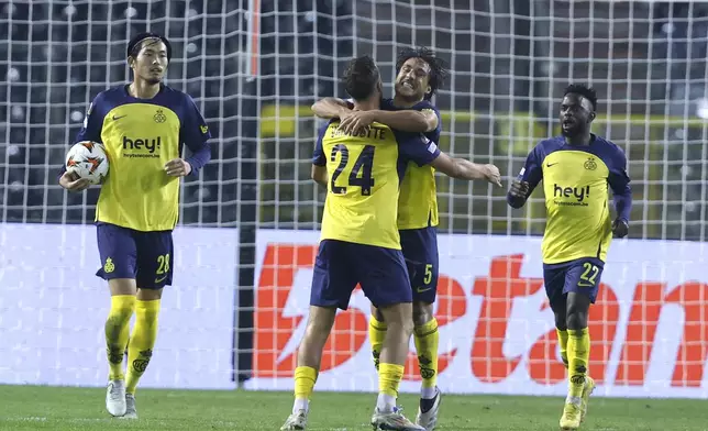 Union SG's Kevin Mac Allister, center right, celebrates with teammate Union SG's Charles Vanhoutte after scoring his sides first goal during the Europa League opening phase soccer match between Union SG and Roma at the King Baudouin stadium in Brussels, Thursday, Nov. 7, 2024. (AP Photo/Omar Havana)