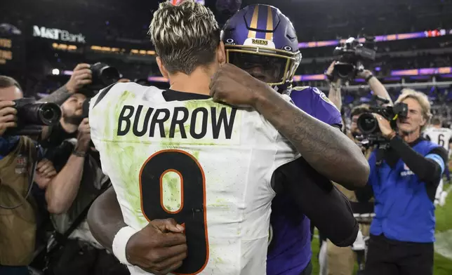 Cincinnati Bengals quarterback Joe Burrow (9) and Baltimore Ravens quarterback Lamar Jackson (8) embrace after an NFL football game, Thursday, Nov. 7, 2024, in Baltimore. The Ravens won 35-34. (AP Photo/Nick Wass)