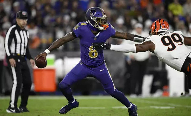 Baltimore Ravens quarterback Lamar Jackson (8) is pressures by Cincinnati Bengals defensive end Myles Murphy (99) during the second half of an NFL football game, Thursday, Nov. 7, 2024, in Baltimore. (AP Photo/Nick Wass)