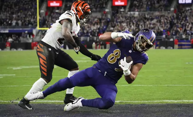 Baltimore Ravens tight end Mark Andrews (89) scores a touchdown past Cincinnati Bengals safety Geno Stone (22) during the second half of an NFL football game, Thursday, Nov. 7, 2024, in Baltimore. (AP Photo/Nick Wass)