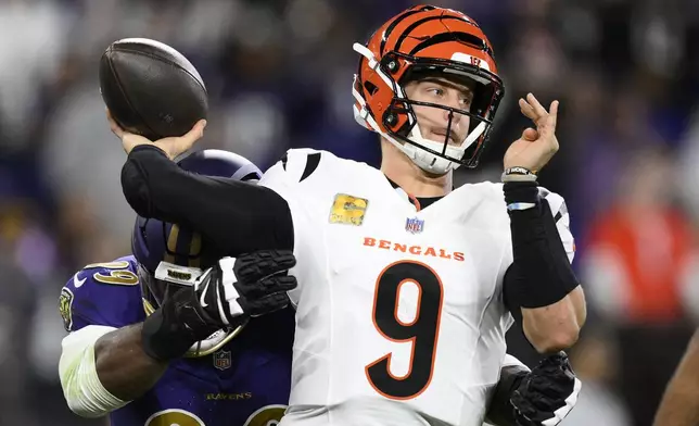 Baltimore Ravens linebacker Odafe Oweh, left, pressures Cincinnati Bengals quarterback Joe Burrow (9) as he passes the ball during the first half of an NFL football game, Thursday, Nov. 7, 2024, in Baltimore. (AP Photo/Nick Wass)