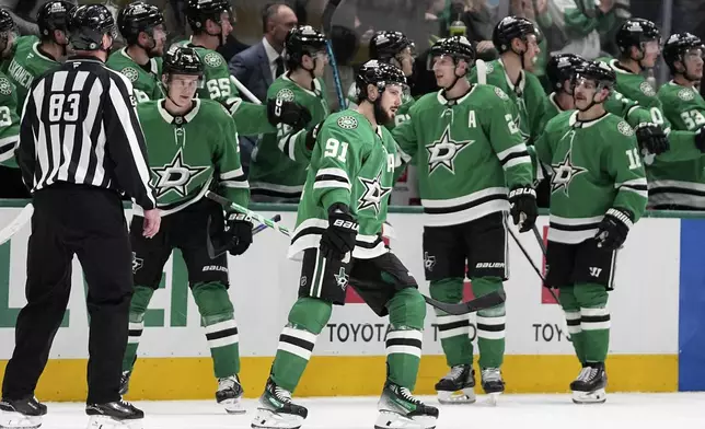 Dallas Stars center Tyler Seguin (91) and the rest of the line celebrate with the bench after Seguin scored in the second period of an NHL hockey game aginst the Chicago Blackhawks in Dallas, Thursday, Nov. 7, 2024. (AP Photo/Tony Gutierrez)