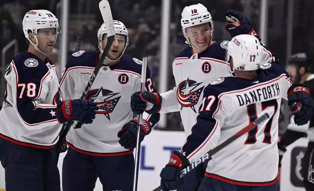 Columbus Blue Jackets left wing Dmitri Voronkov (10) celebrates after scoring against the Los Angeles Kings with right wing Justin Danforth (17), defenseman Damon Severson (78) and right wing Mathieu Olivier (24) during the first period of an NHL hockey game in Los Angeles, Saturday, Nov. 9, 2024. (AP Photo/Alex Gallardo)