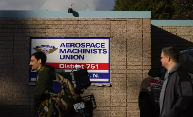 Boeing employees on strike arrive to vote on a new contract offer from the company, Wednesday, Oct. 23, 2024, at the Aerospace Machinists Union hall in Renton, Wash. (AP Photo/Lindsey Wasson)