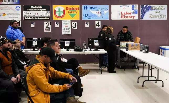 Observers watch as volunteers tally votes on a new contract offer from Boeing, Monday, Nov. 4, 2024, at IAM District 751 Union Hall in Seattle. (AP Photo/Lindsey Wasson)