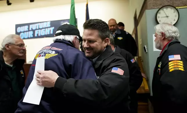 IAM District 751 president Jon Holden greets union members after announcing they voted to accept a new contract offer from Boeing, Monday, Nov. 4, 2024, at their union hall in Seattle. (AP Photo/Lindsey Wasson)