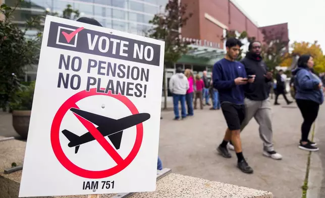 A picket sign sits outside the Angel of the Winds Arena as striking Boeing employees gather to cast their votes, Wednesday, Oct. 23, 2024, in Everett, Wash. (AP Photo/Lindsey Wasson)