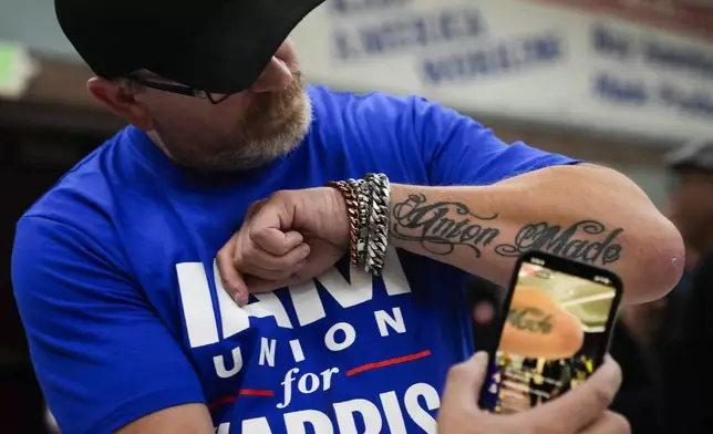 Ed Lutgen shows off his tattoo while waiting to hear the results of the union vote on a new contract offer from Boeing, Monday, Nov. 4, 2024, at IAM District 751 Union Hall in Seattle. (AP Photo/Lindsey Wasson)