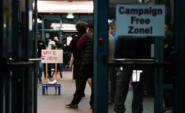 Boeing employees line up to vote on a new contract offer from the company, Monday, Nov. 4, 2024, at the IAM District 751 Union Hall in Seattle. (AP Photo/Lindsey Wasson)