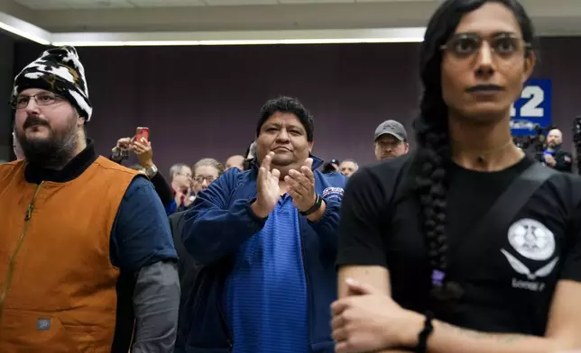 Union members react as IAM District 751 president Jon Holden announces that they voted to accept a new contract offer from Boeing, Monday, Nov. 4, 2024, at their union Hall in Seattle. (AP Photo/Lindsey Wasson)