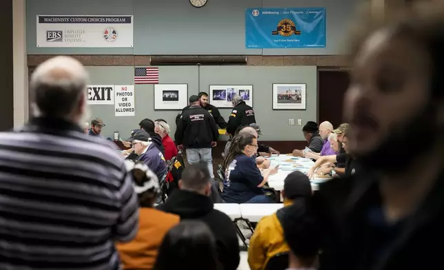 Observers watch as volunteers tally votes on a new contract offer from Boeing, Monday, Nov. 4, 2024, at the IAM District 751 Union Hall in Seattle. (AP Photo/Lindsey Wasson)