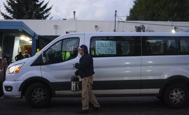 A Boeing employee driving a "union express" van carries carafes as workers vote on a new contract offer from the company Monday, Nov. 4, 2024, at the Aerospace Machinists Union hall in Renton, Wash. (AP Photo/Lindsey Wasson)