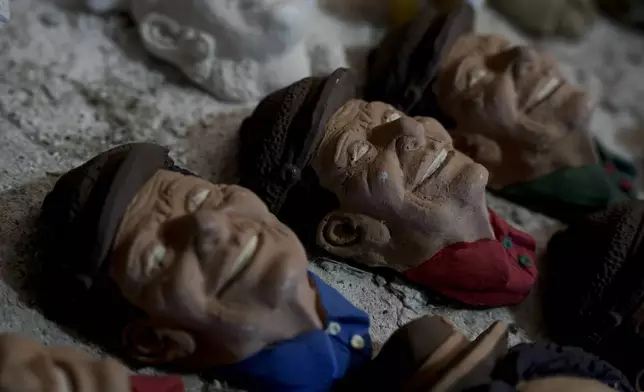 Masks created by artisan William Luna to adorn a sweet bread called tantawawa, traditional for Day of the Dead celebrations, are set on a table at his workspace, in La Paz, Bolivia, Thursday, Oct. 31, 2024. (AP Photo/Freddy Barragan)