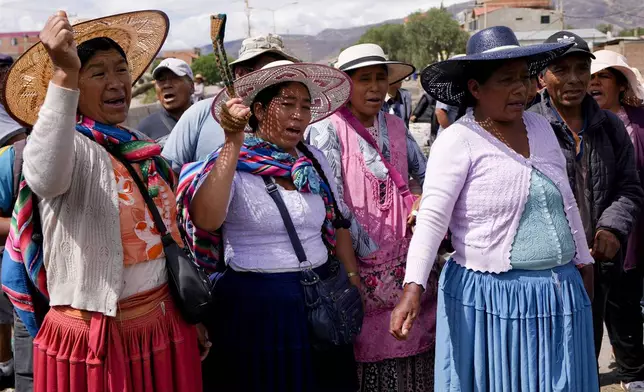 Supporters of Bolivian former President Evo Morales shout slogans as they block a road to prevent him from facing a criminal investigation over allegations of abuse of a minor and to demonstrate against an alleged assassination attempt, near Cochabamba, Bolivia, Monday, Oct. 28, 2024. (AP Photo/Juan Karita)