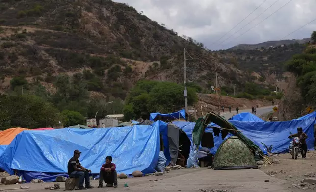 Supporters of former President Evo Morales block a road to prevent him from facing a criminal investigation over allegations of abuse of a minor and to demonstrate against an alleged assassination attempt, in Parotani, Bolivia, Thursday, Oct. 31, 2024. (AP Photo/Juan Karita)