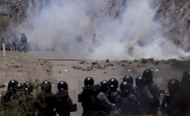 Police launch tear gas to disperse supporters of former President Evo Morales who have been blocking roads for days to prevent him from facing a criminal investigation over allegations of abuse of a minor while he was in office, in Parotani, Bolivia, Friday, Nov. 1, 2024. (AP Photo/Juan Karita)