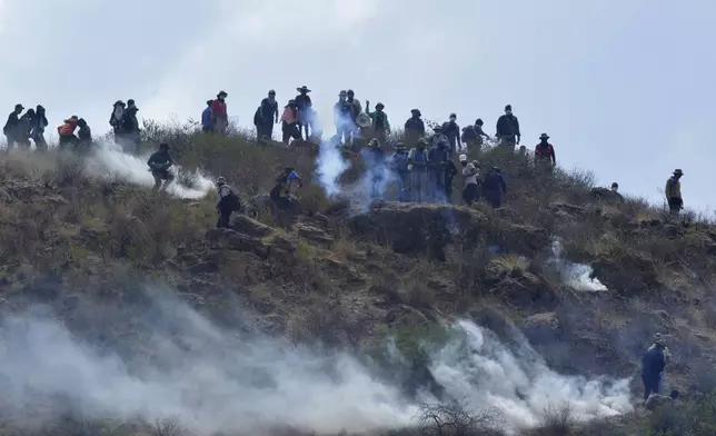 Supporters of former Bolivian President Evo Morales clash with police during a roadblock to pressure against him being prosecuted over allegations of minor abuse, near Cochabamba, Bolivia, Friday, Oct. 25, 2024. (AP Photo/Daniel Cartagena)