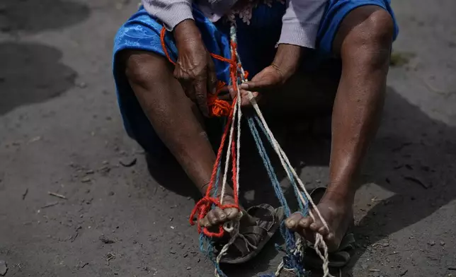 A protester weaves a sling during roadblock in support of former President Evo Morales in the face of an investigation opened against him for the alleged abuse of a minor while in office, in Parotani, Bolivia, Thursday, Oct. 31, 2024. (AP Photo/Juan Karita)