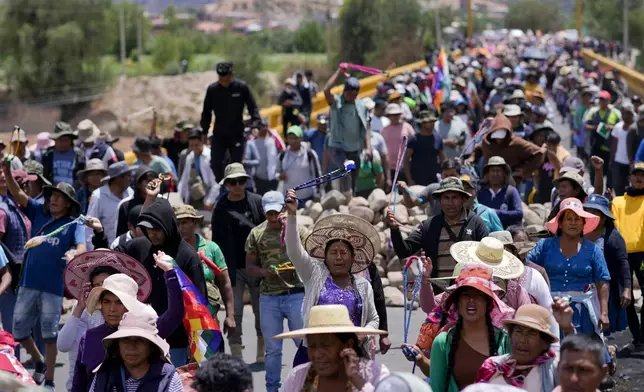 Supporters of Bolivian former President Evo Morales block a road to prevent him from facing a criminal investigation over allegations of abuse of a minor and to demonstrate against an alleged assassination attempt, in Parotani, Bolivia, Tuesday, Oct. 29, 2024. (AP Photo/Juan Karita)