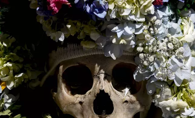 A decorated human skull sits at the General Cemetery as part of the annual “Ñatitas” festival, a tradition marking the end of the Catholic holiday of All Saints, in La Paz, Bolivia, Friday, Nov. 8, 2024. (AP Photo/Juan Karita)