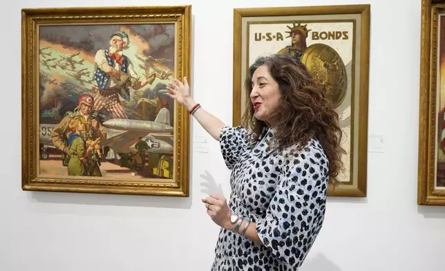 Aviva Lehmann, Heritage Auction's senior vice president of American art, responds to a question as she stands by paintings in Dallas, Thursday, Oct. 17, 2024, that are some of many works from the Boy Scouts of America's art collection — including some paintings by Norman Rockwell — that will go up for auction this month to help compensate tens of thousands of people, mainly men, who were sexually abused while in scouting. (AP Photo/Tony Gutierrez)