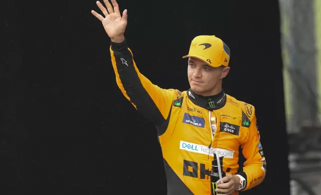 Pole position winner, McLaren driver Lando Norris of Britain, celebrates after the qualifying session ahead of the Brazilian Formula One Grand Prix at the Interlagos race track, in Sao Paulo, Brazil, Sunday, Nov. 3, 2024. (AP Photo/Andre Penner)