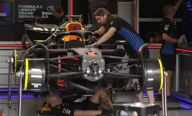 Crew members work on the car of Red Bull driver Max Verstappen, of the Netherlands, ahead of the Brazilian Formula One Grand Prix at the Interlagos race track in Sao Paulo, Brazil, Thursday, Oct. 31, 2024. (AP Photo/Andre Penner)