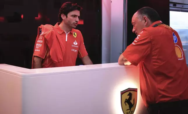 Ferrari driver Carlos Sainz of Spain, left, talks with Ferrari Team Principal Frederic Vasseur ahead of the Brazilian Formula One Grand Prix at the Interlagos race track, in Sao Paulo, Brazil, Sunday, Nov. 3, 2024. (AP Photo/Ettore Chiereguini)