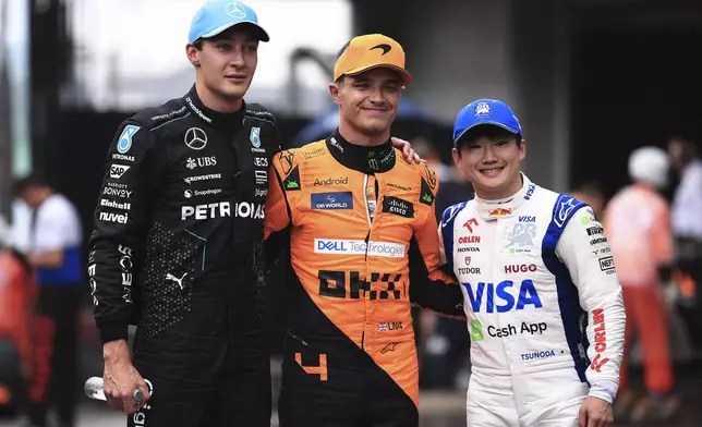 First-place finisher McLaren driver Lando Norris of Britain, center, poses for a photo with second-place finisher Mercedes driver George Russell of Britain, left, and third-place finisher RB driver Yuki Tsunoda of Japan at the end of the qualifying session ahead to the Brazilian Formula One Grand Prix at the Interlagos race track, in Sao Paulo, Brazil, Sunday, Nov. 3, 2024. (AP Photo/Ettore Chiereguini)