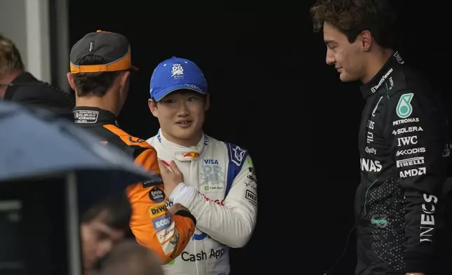 RB driver Yuki Tsunoda of Japan, center, talks with Mercedes driver George Russell of Britain, right, and McLaren driver Lando Norris of Britain, after the qualifying session ahead of the Brazilian Formula One Grand Prix at the Interlagos race track, in Sao Paulo, Brazil, Sunday, Nov. 3, 2024. (AP Photo/Andre Penner)