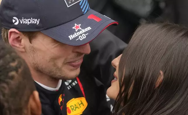 Red Bull driver Max Verstappen, of the Netherlands, embraces his wife, Kelly Piquet, after winning the Brazilian Formula One Grand Prix at the Interlagos race track in Sao Paulo, Sunday, Nov. 3, 2024. (AP Photo/Andre Penner)