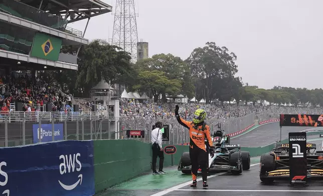 Pole position winner, McLaren driver Lando Norris of Britain, celebrates after the qualifying session ahead of the Brazilian Formula One Grand Prix at the Interlagos race track, in Sao Paulo, Brazil, Sunday, Nov. 3, 2024. (AP Photo/Ettore Chiereguini)