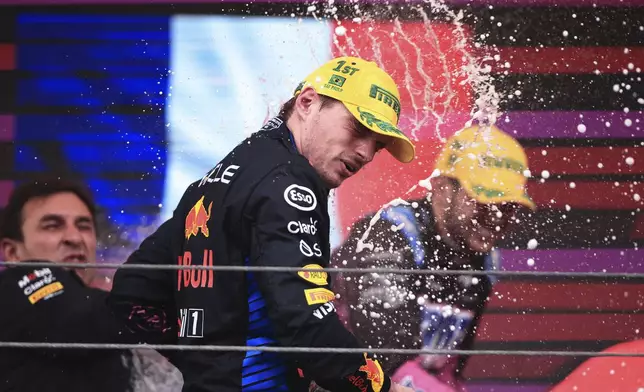 Red Bull driver Max Verstappen of the Netherlands, sprays champagne at the podium after winning the Brazilian Formula One Grand Prix at the Interlagos race track, in Sao Paulo, Brazil, Sunday, Nov. 3, 2024. (AP Photo/Ettore Chiereguini)