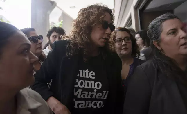 Monica Benicio, center, widow of slain councilwoman Marielle Franco, arrives to the Court of Justice to attend the trial of Franco's suspected murderers, in Rio de Janeiro, Wednesday, Oct. 30, 2024. (AP Photo/Bruna Prado)