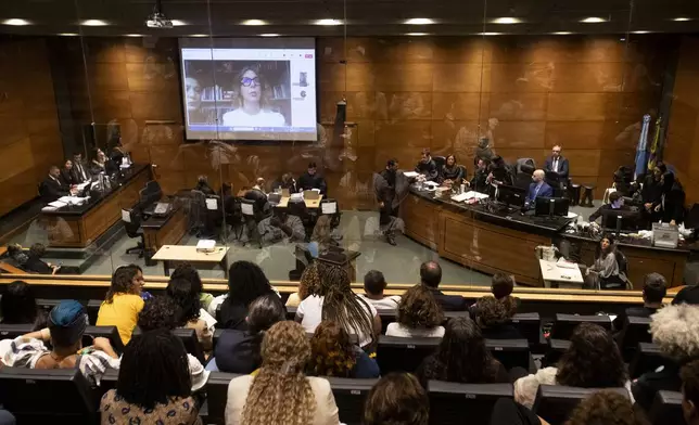 Advisor to slain city councilwoman Marielle Franco, Fernanda Goncalves Chaves, pictured on screen, testifies during the trial of Franco's suspected murderers, at the Court of Justice in Rio de Janeiro, Wednesday, Oct. 30, 2024. (AP Photo/Bruna Prado)