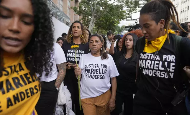 Anielle Franco, left back, and her mother Marinete Silva, center, family members of of slain councilwoman Marielle Franco, arrive to the Court of Justice to attend the trial of Franco’s suspected murderers, in Rio de Janeiro, Brazil, Wednesday, Oct. 30, 2024. (AP Photo/Silvia Izquierdo)